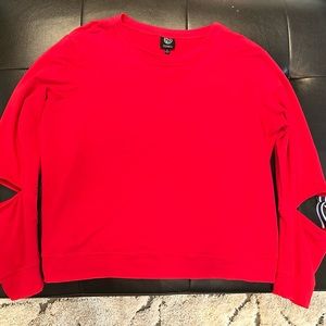 Babeau bright red sweatshirt with split navy/white buckled sleeves.